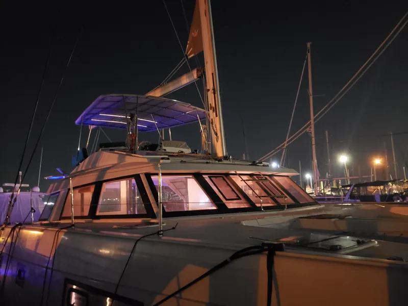 Slide: The Image of 2017 Nautitech 46 Fly catamaran docked at night, illuminated by marina lights. - 43