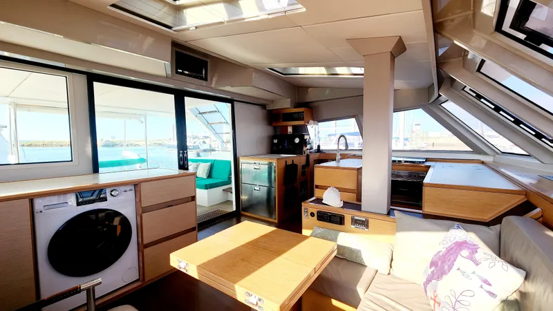 Slide: The Image of Interior of 2017 Nautitech 46 Fly catamaran, featuring modern kitchen and seating area with ocean view. - 5