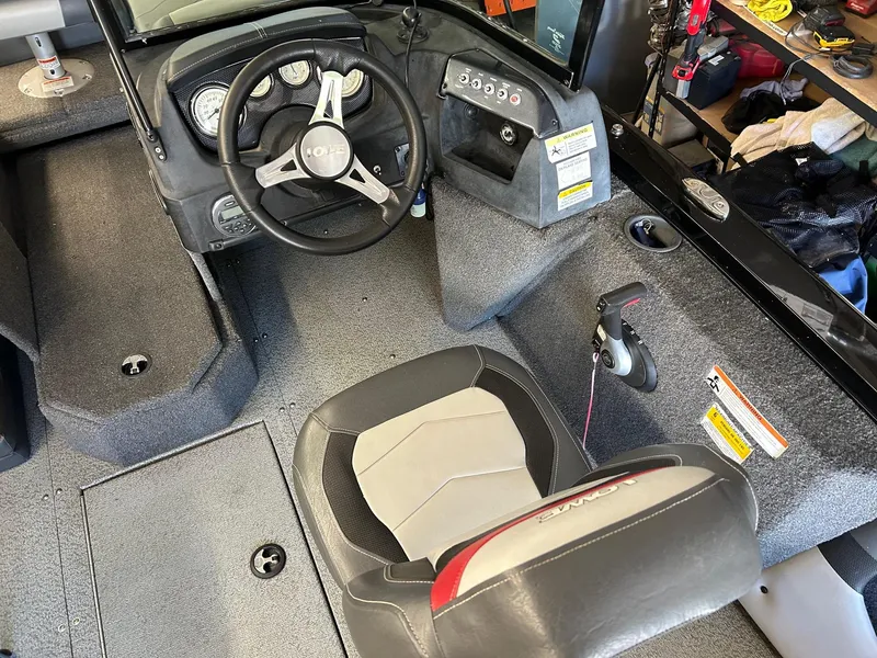 Slide: The Image of 2017 Lowe Fish & Ski FS1710 boat interior with steering wheel and seat. - 4