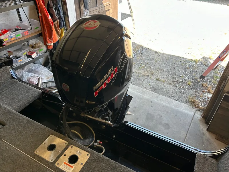 Slide: The Image of 2017 Lowe Fish & Ski FS1710 with Mercury Pro outboard motor in a garage setting. - 5