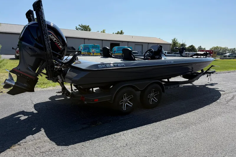 Slide: The Image of 2025 Skeeter ZXR21 boat on trailer, parked outdoors, showcasing sleek design and powerful engine. - 10