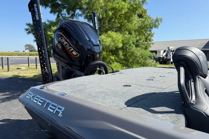 Slide: The Image of 2025 Skeeter ZXR21 boat with Yamaha engine and Minn Kota Raptor, parked outdoors. - 12