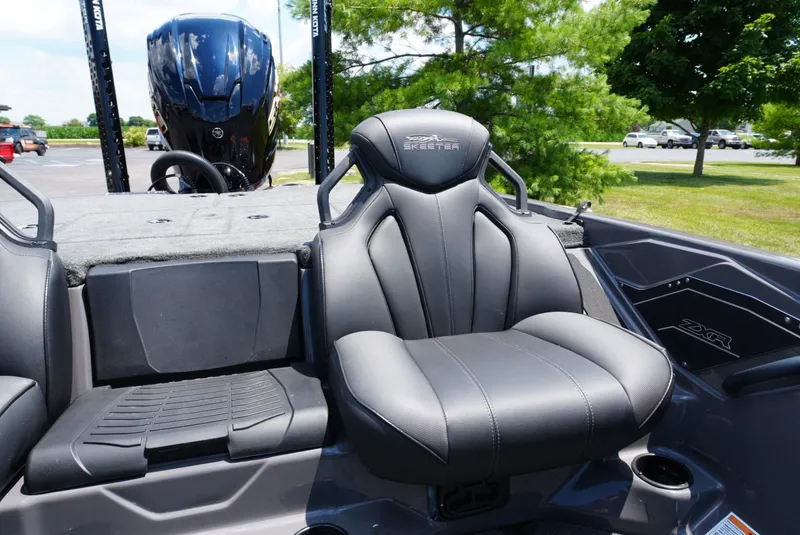 Slide: The Image of 2025 Skeeter ZXR21 boat interior with sleek seating and powerful engine in a sunny outdoor setting. - 13