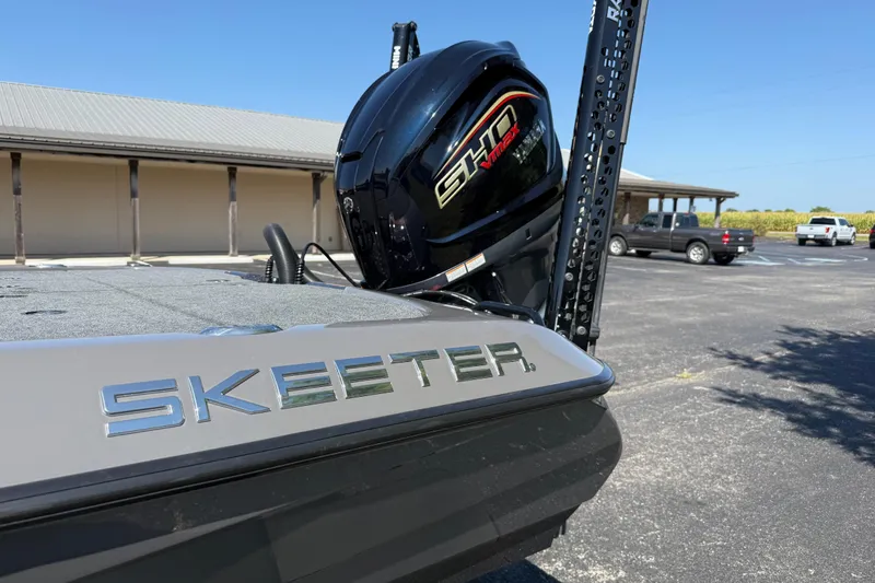 Slide: The Image of 2025 Skeeter ZXR21 boat with powerful engine, parked outdoors on a sunny day. - 17