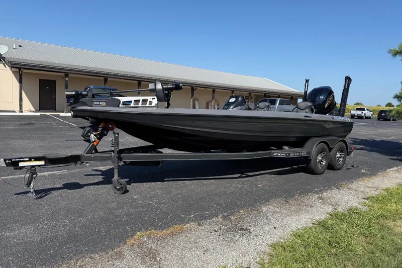 Slide: The Image of 2025 Skeeter ZXR21 fishing boat on trailer in parking lot, sunny day. - 4