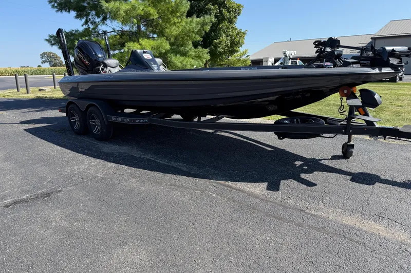 Slide: The Image of 2025 Skeeter ZXR21 boat on trailer, parked outdoors on sunny day. - 9