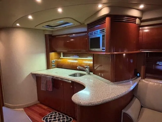 Slide: The Image of Luxurious 2005 Sea Ray 500 Sundancer yacht interior with modern kitchen and elegant wood finishes. - 24