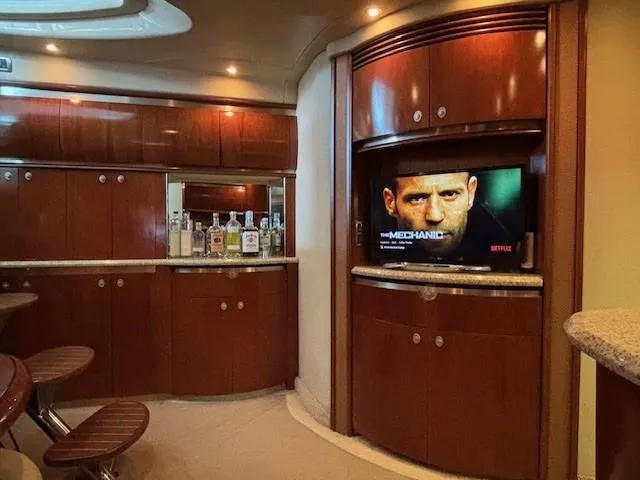 Slide: The Image of Luxurious interior of 2005 Sea Ray 500 Sundancer yacht with TV and bar area. - 26
