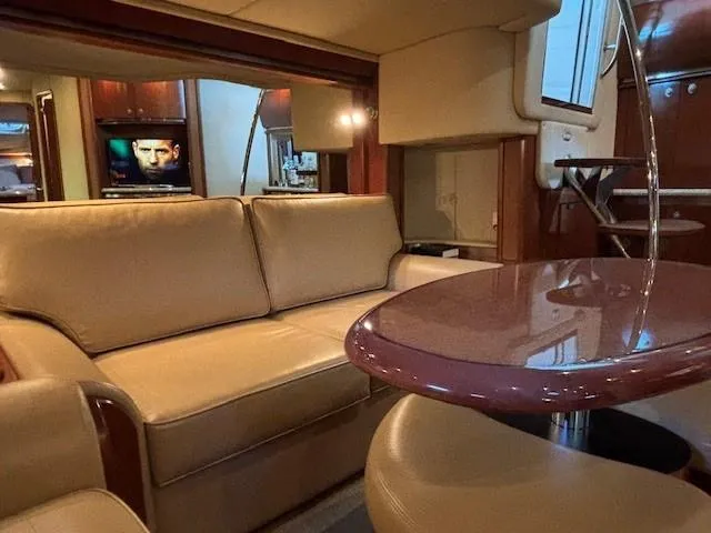 Slide: The Image of Luxurious interior of 2005 Sea Ray 500 Sundancer yacht with beige seating and wooden accents. - 27