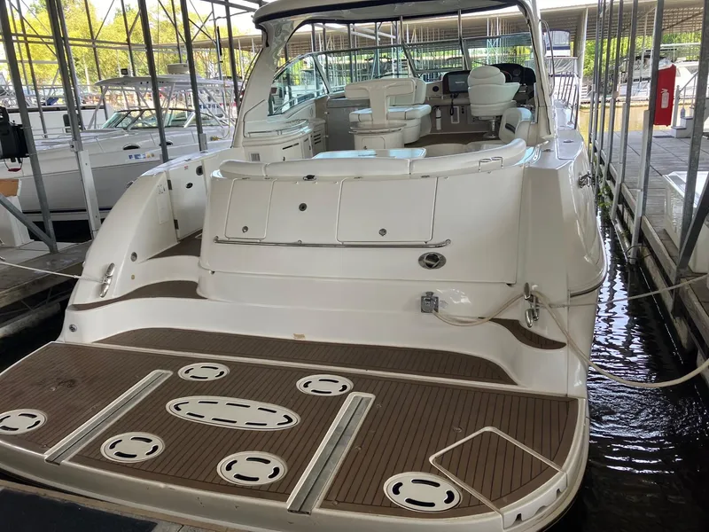 Slide: The Image of 2005 Sea Ray 500 Sundancer yacht docked, showcasing spacious deck and luxurious interior. - 3