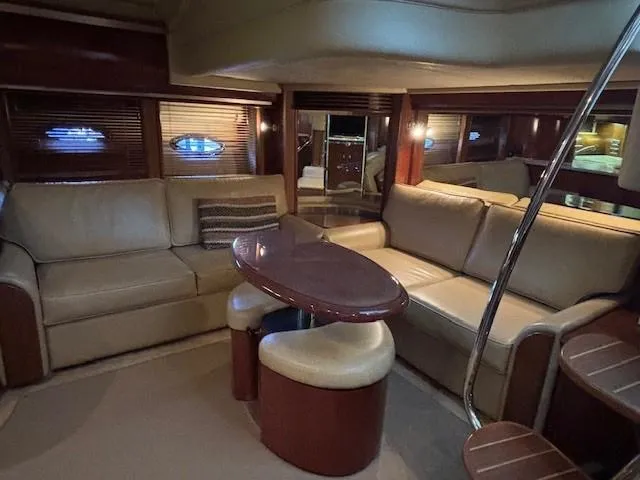Slide: The Image of Luxurious interior of 2005 Sea Ray 500 Sundancer yacht with leather seating and wooden accents. - 32