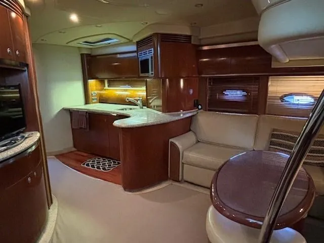 Slide: The Image of Luxurious interior of a 2005 Sea Ray 500 Sundancer yacht with modern kitchen and seating area. - 33