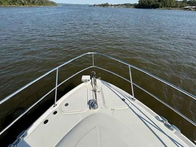 Slide: The Image of Bow view of 2005 Sea Ray 500 Sundancer cruising on a calm river. - 37