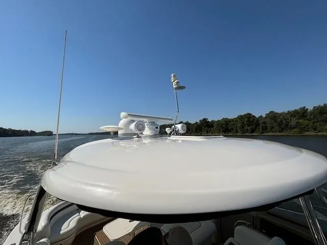 Slide: The Image of 2005 Sea Ray 500 Sundancer cruising on a river under clear blue skies. - 41
