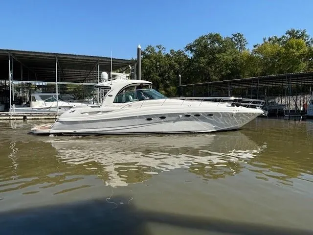 Slide: The Image of 2005 Sea Ray 500 Sundancer yacht docked on calm water under clear blue sky. - 47