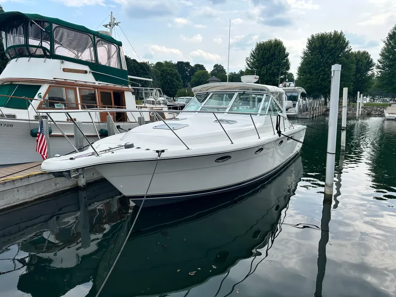 Slide: The Image of 2003 Tiara Yachts 3100 Open docked at marina, surrounded by other boats. - 15