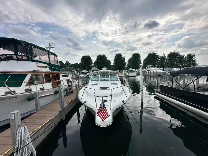 Slide: The Image of 2003 Tiara Yachts 3100 Open docked at marina under cloudy sky. - 18