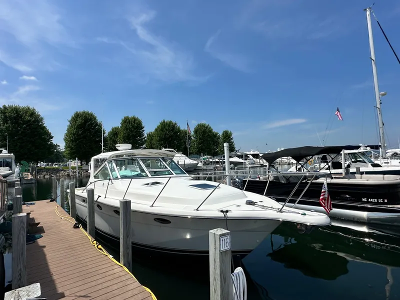 Slide: The Image of 2003 Tiara Yachts 3100 Open docked at marina under clear blue sky. - 19