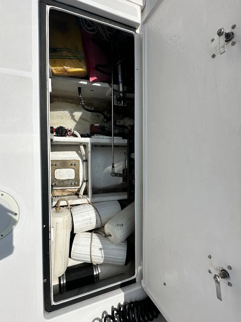 Slide: The Image of Storage compartment of a 2003 Tiara Yachts 3100 Open, containing boat fenders and equipment. - 21