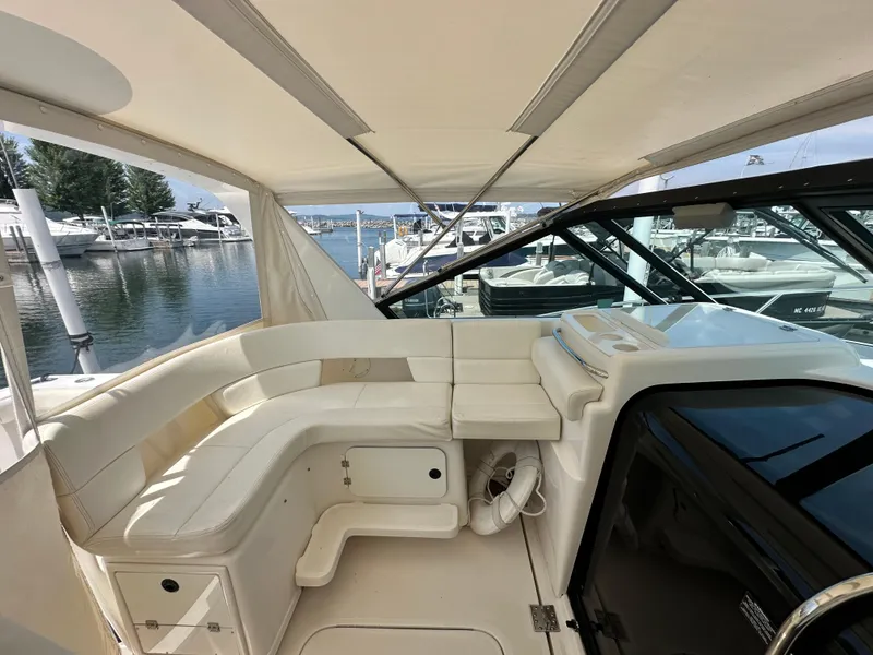 Slide: The Image of 2003 Tiara Yachts 3100 Open interior with white seating, docked at marina. - 22