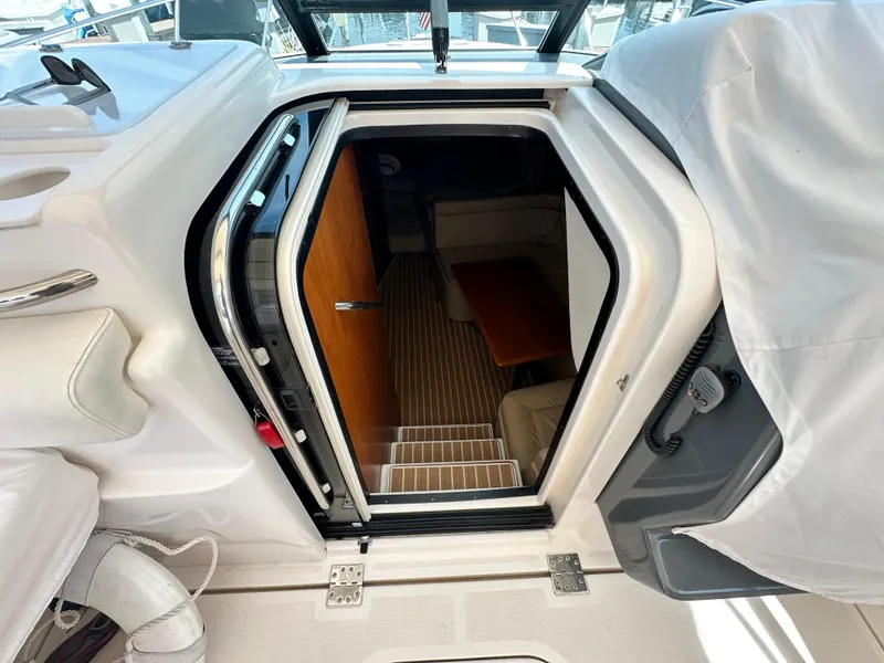 Slide: The Image of 2003 Tiara Yachts 3100 Open cabin entrance with wooden interior and seating area. - 23