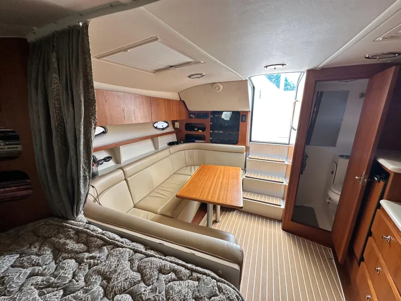 Slide: The Image of 2003 Tiara Yachts 3100 Open interior with seating, table, and cabin amenities. - 25
