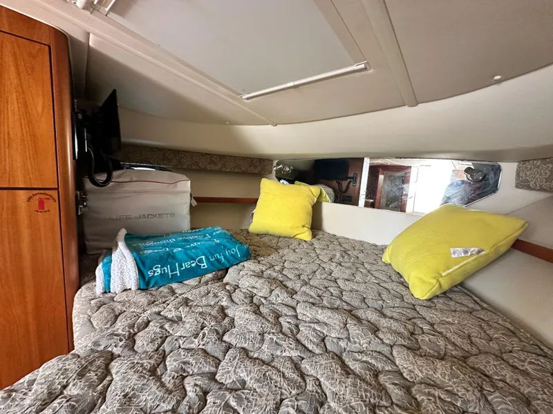 Slide: The Image of Cozy cabin interior of 2003 Tiara Yachts 3100 Open with bed, pillows, and life jackets. - 27
