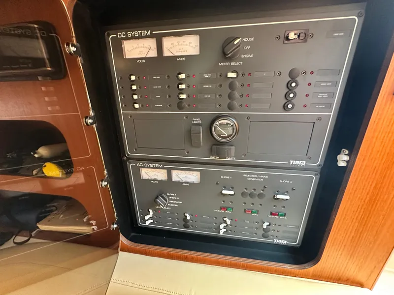 Slide: The Image of Control panel of a 2003 Tiara Yachts 3100 Open, featuring DC and AC systems. - 31