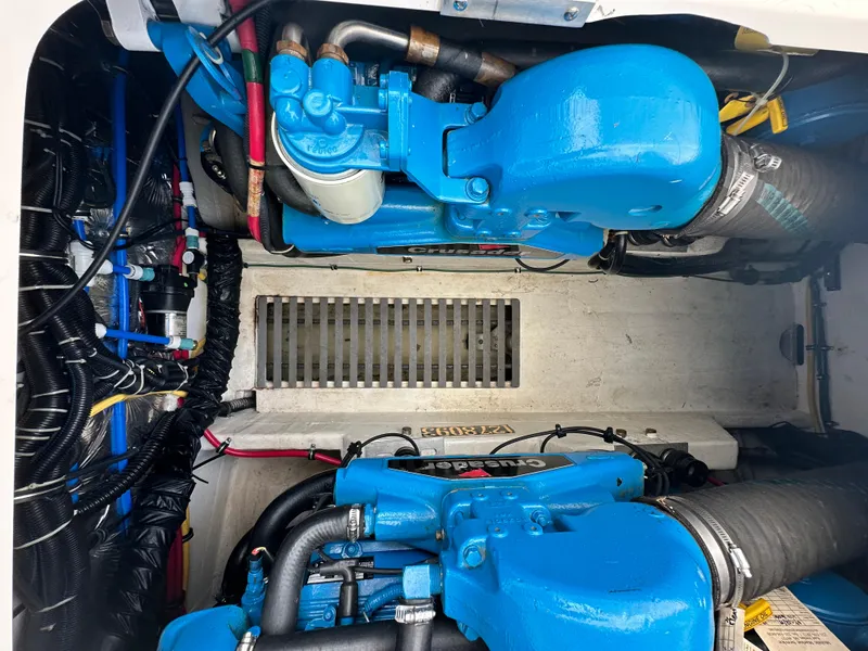 Slide: The Image of Engine compartment of a 2003 Tiara Yachts 3100 Open, featuring blue engine components. - 33