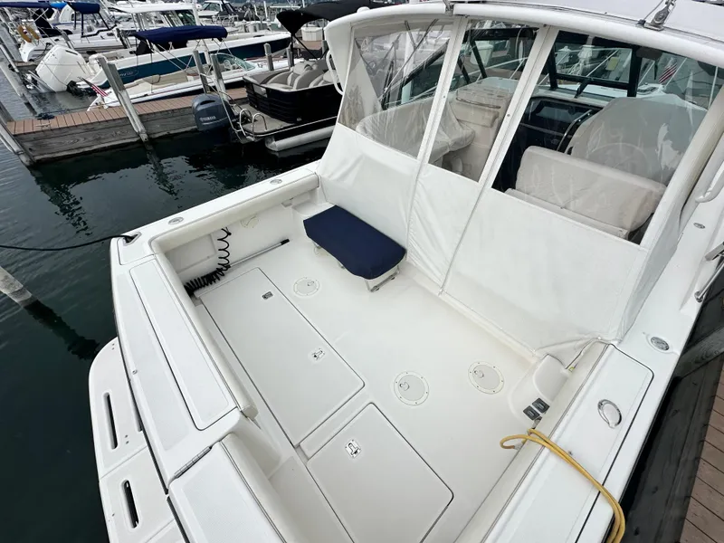 Slide: The Image of 2003 Tiara Yachts 3100 Open boat docked, featuring spacious deck and seating area. - 6