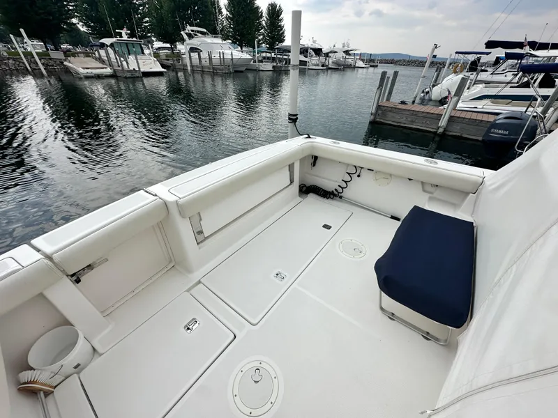 Slide: The Image of 2003 Tiara Yachts 3100 Open boat interior at marina, featuring spacious seating and clean design. - 8