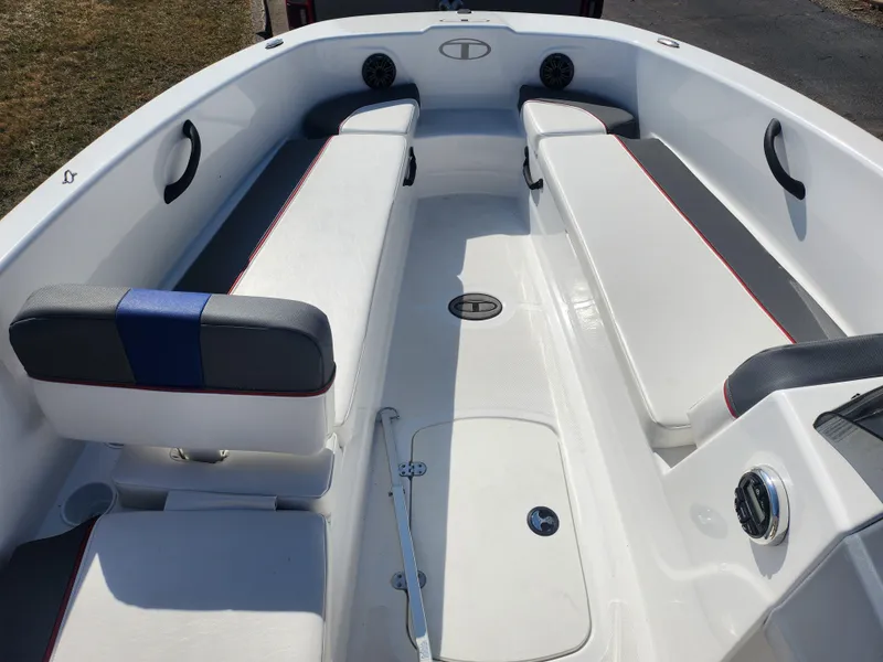 Slide: The Image of 2023 Tahoe T18 boat interior with white seating and blue accents. - 13
