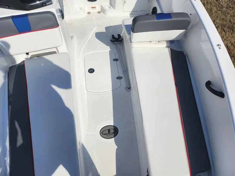 Slide: The Image of 2023 Tahoe T18 boat interior with white seating and blue accents. - 16