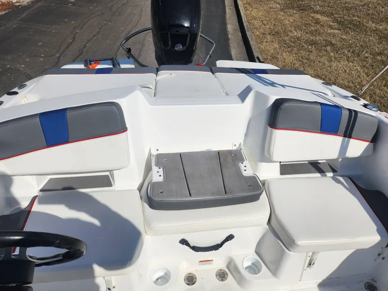 Slide: The Image of 2023 Tahoe T18 boat interior with white and blue seating, featuring a sleek design. - 19