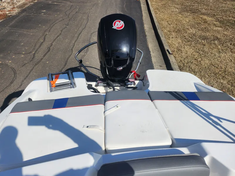 Slide: The Image of 2023 Tahoe T18 boat with outboard motor, parked on a paved road. - 21