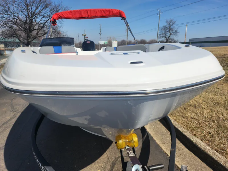 Slide: The Image of 2023 Tahoe T18 boat on trailer, white hull, red canopy, outdoor setting. - 6