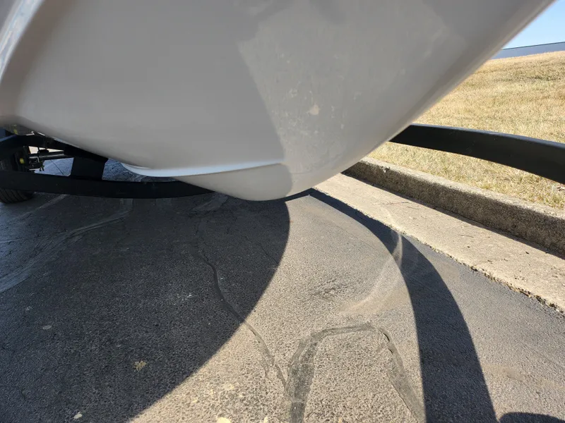 Slide: The Image of Close-up of 2023 Tahoe T18 boat hull on trailer, parked on pavement. - 7
