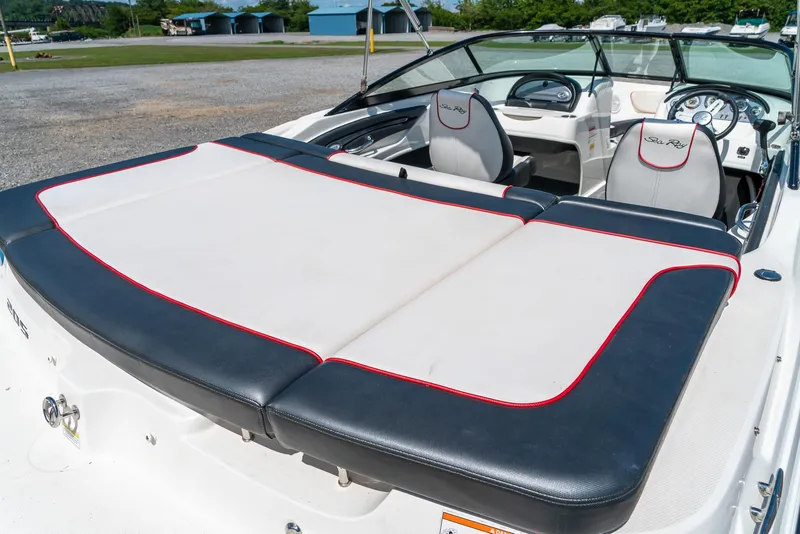 Slide: The Image of 2014 Sea Ray 205 Sport boat interior with cushioned seating and steering wheel. - 10
