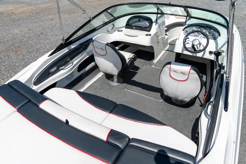 Slide: The Image of 2014 Sea Ray 205 Sport boat interior with sleek seating and modern dashboard design. - 11