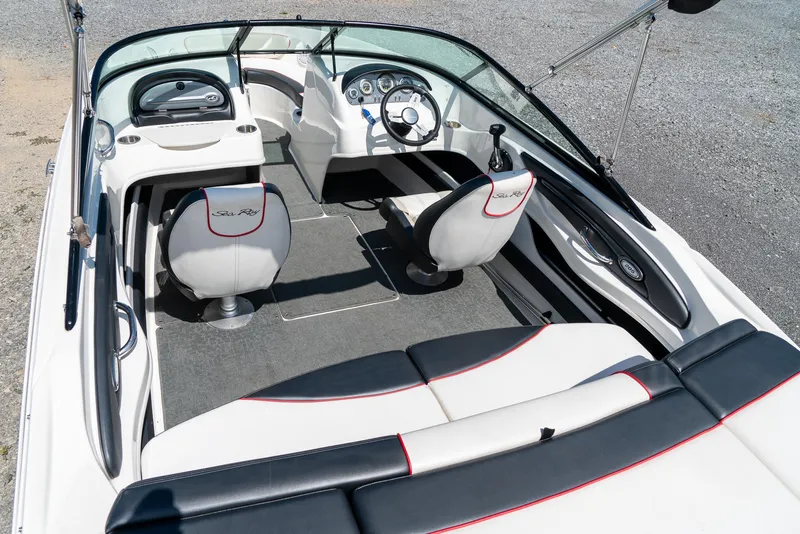 Slide: The Image of 2014 Sea Ray 205 Sport boat interior with sleek seating and modern dashboard design. - 12