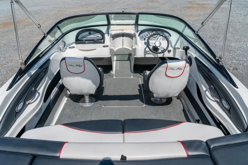 Slide: The Image of 2014 Sea Ray 205 Sport boat interior with dual seats and steering wheel. - 13