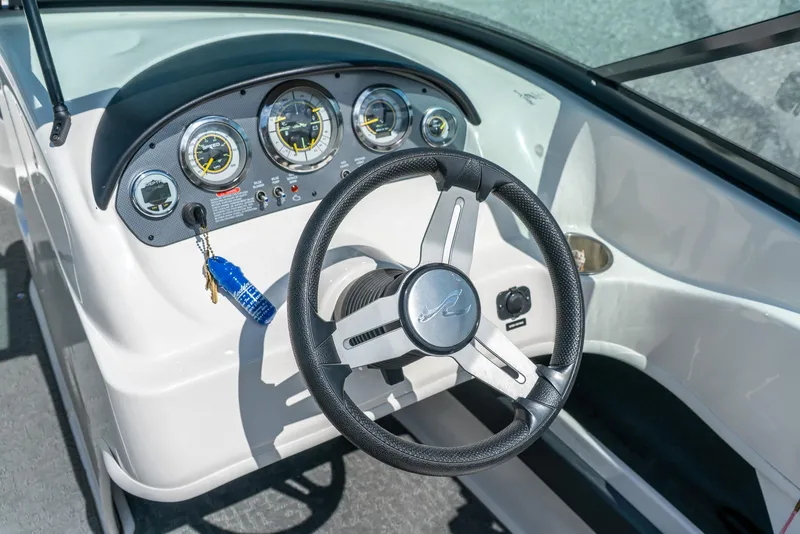Slide: The Image of 2014 Sea Ray 205 Sport dashboard with steering wheel and instrument panel. - 15