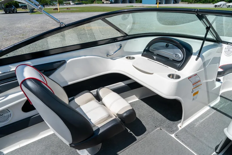 Slide: The Image of 2014 Sea Ray 205 Sport boat interior with sleek seating and modern dashboard design. - 16