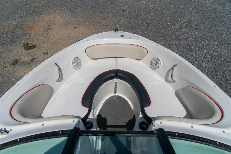 Slide: The Image of 2014 Sea Ray 205 Sport boat interior with cushioned seating and speakers. - 17