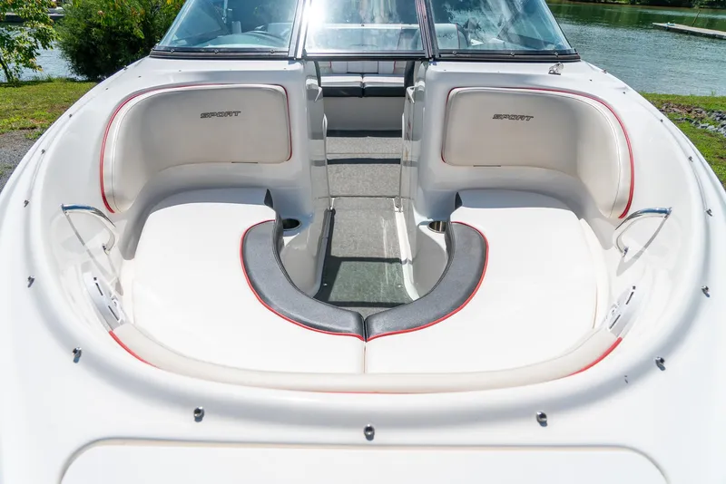 Slide: The Image of 2014 Sea Ray 205 Sport boat interior with white seating and red accents. - 18