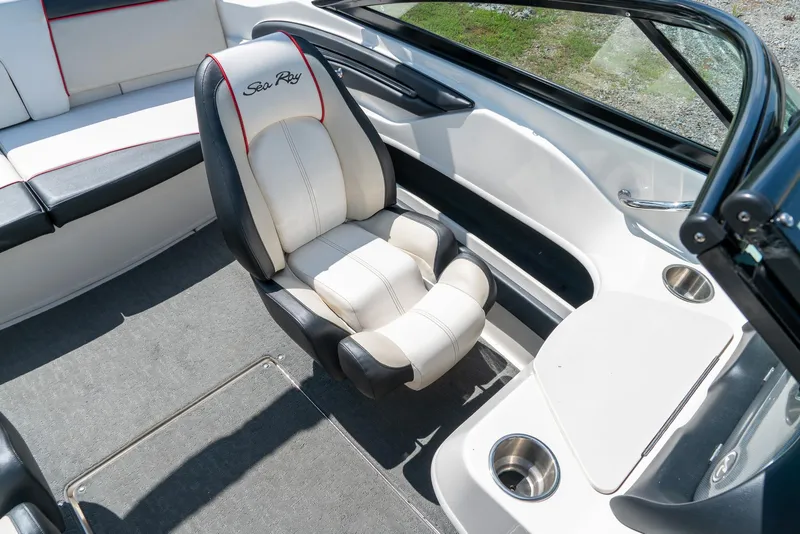 Slide: The Image of 2014 Sea Ray 205 Sport boat interior with white seating and cup holders. - 21