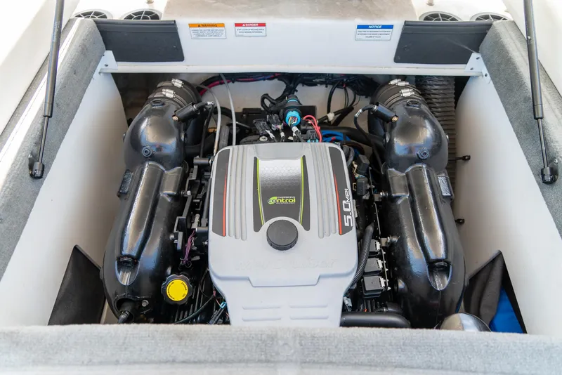 Slide: The Image of Engine compartment of a 2014 Sea Ray 205 Sport boat, featuring a 5.0 MPI engine. - 23