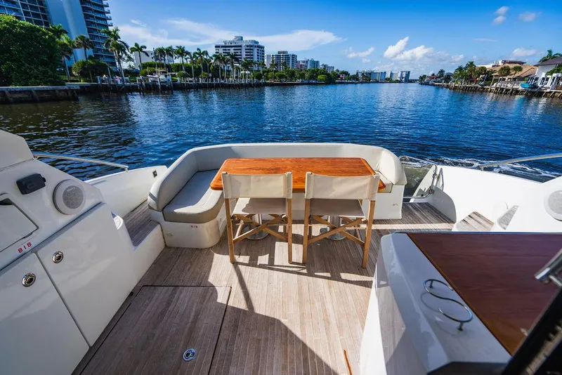 Slide: The Image of Beneteau Gran Turismo 49 yacht deck with seating, overlooking a scenic waterfront view. - 18