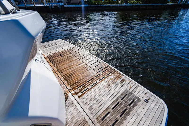 Slide: The Image of 2016 Beneteau GRAN TURISMO 49 yacht with wooden deck by the water. - 19