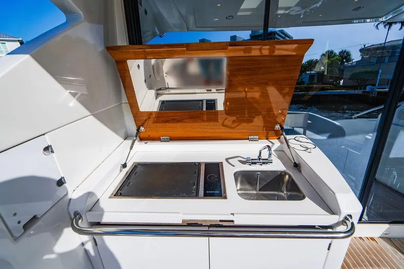 Slide: The Image of Outdoor kitchenette on 2016 Beneteau GRAN TURISMO 49 yacht with sink and grill. - 25